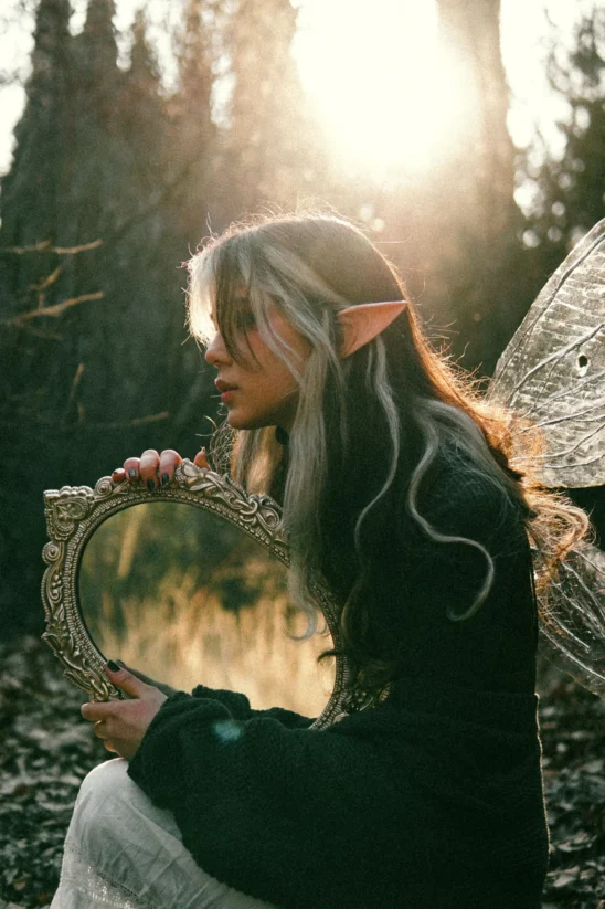 elf holding mirror in forest elf holding mirror in forest
